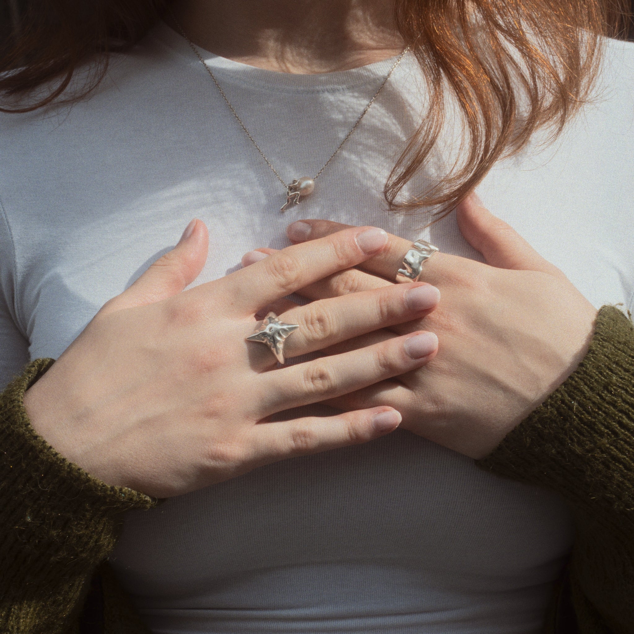 Sisyphus Necklace worn on female model with other jewelry